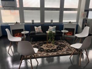 Wellness room with chairs, couch, and fireplace